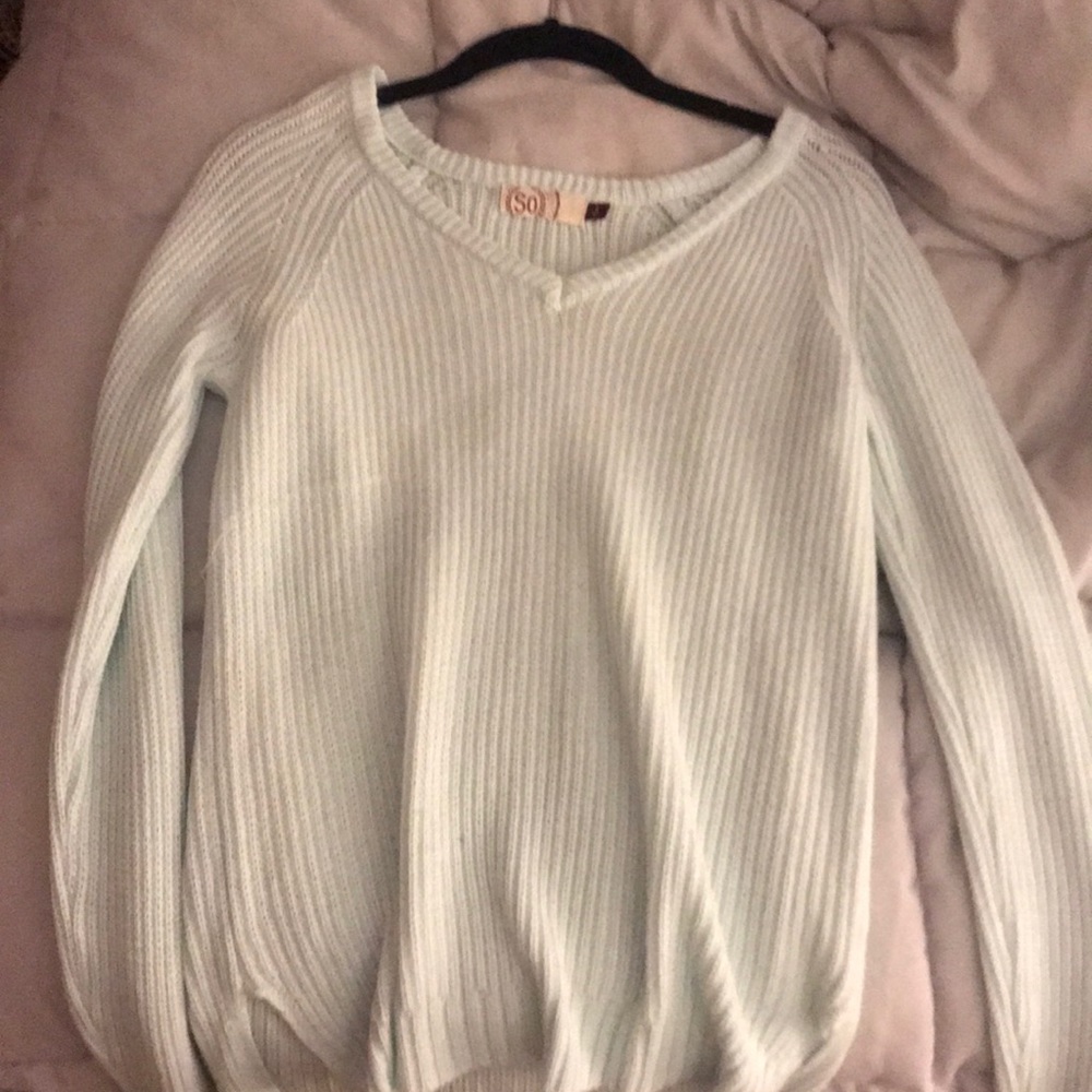 an oversized warm mint green sweater